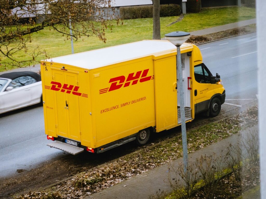 DHL truck parked on a street, seen from a second-story window