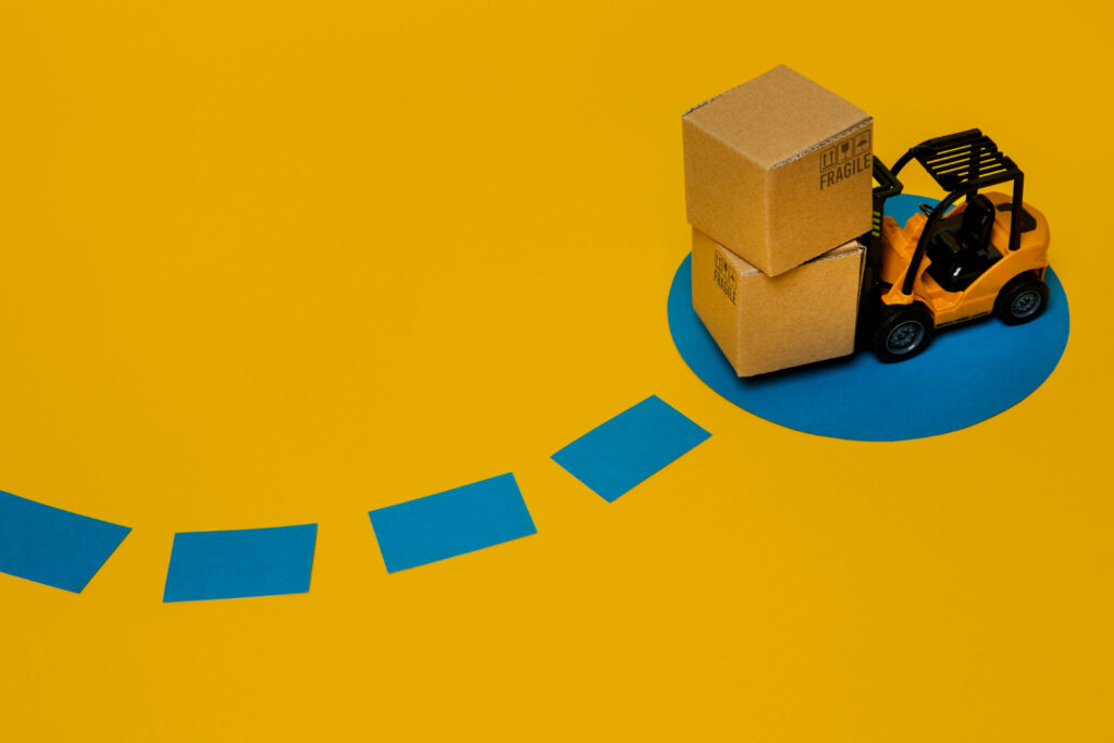 What is Amazon FBA - A toy forklift moving packages, visually representing the handling and shipping aspects of Amazon's Fulfillment by Amazon (FBA) service.